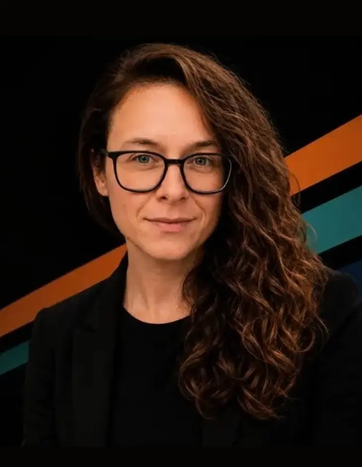 Laurence Paquette, portrait with orange and teal ANYWAY brand accents.